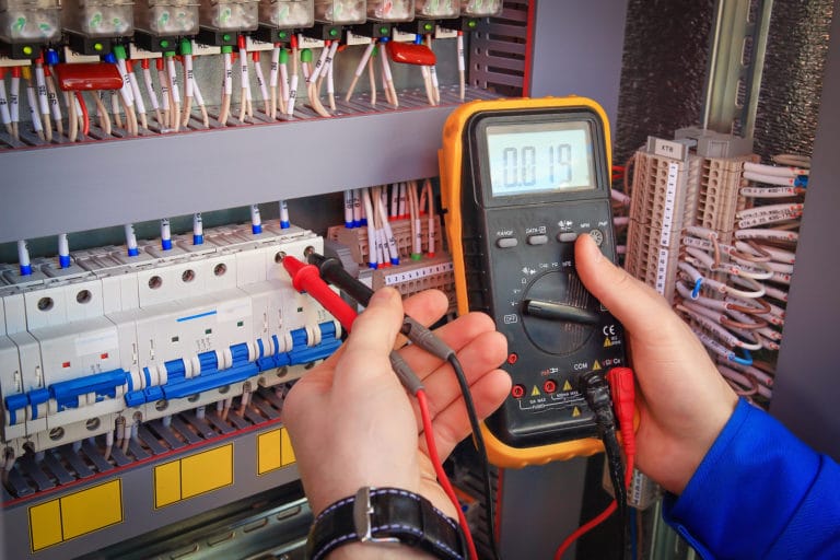Electrician gauging an electric panel
