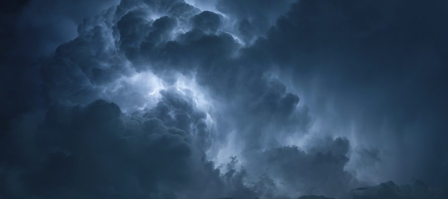 lightning lighting up a cloudy night sky